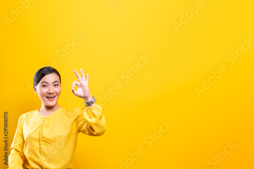 Happy woman showing OK gesture isolated on background