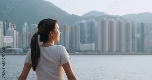 Photography Woman look at the sea view in Hong Kong at sunset time