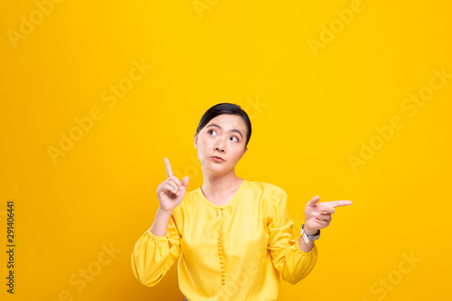 Woman feel confused isolated over yellow background