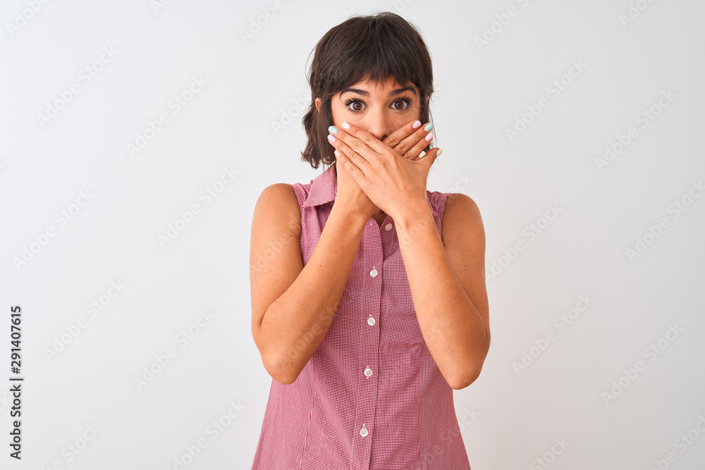 Young beautiful woman wearing red summer shirt standing over isolated white background shocked covering mouth with hands for mistake. Secret concept.