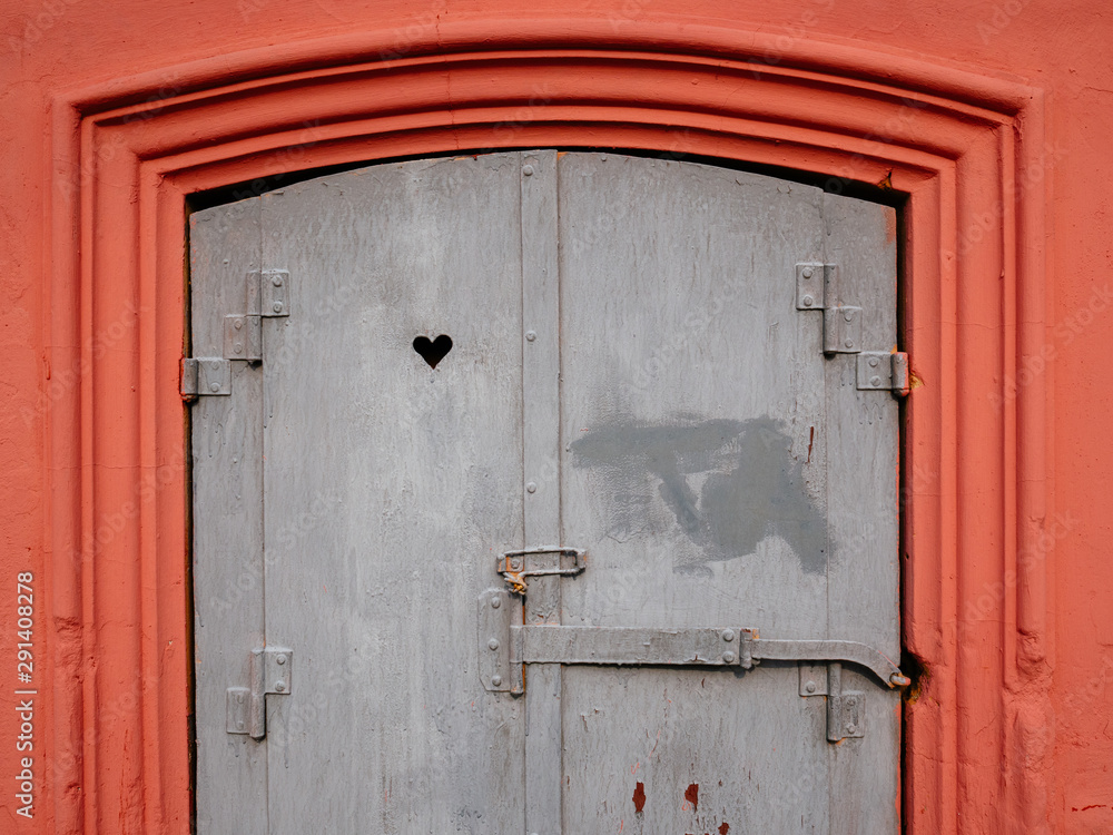 The old window is pink with patterns. The heart shape is carved on the window The old window is pink with patterns. The heart shape is carved on the window