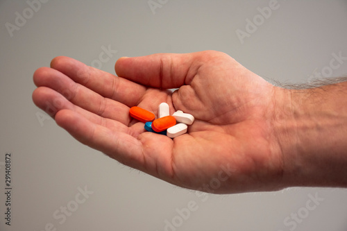 Hand holding pills