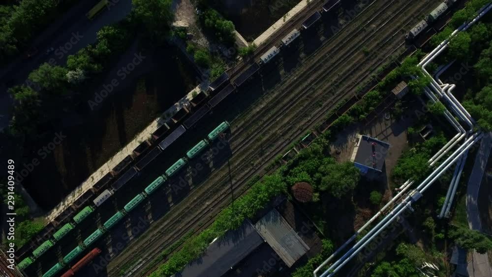 Aerial view freight trains on railway industrial factory. Cargo trains top view Aerial view freight trains on railway industrial factory. Cargo trains top view