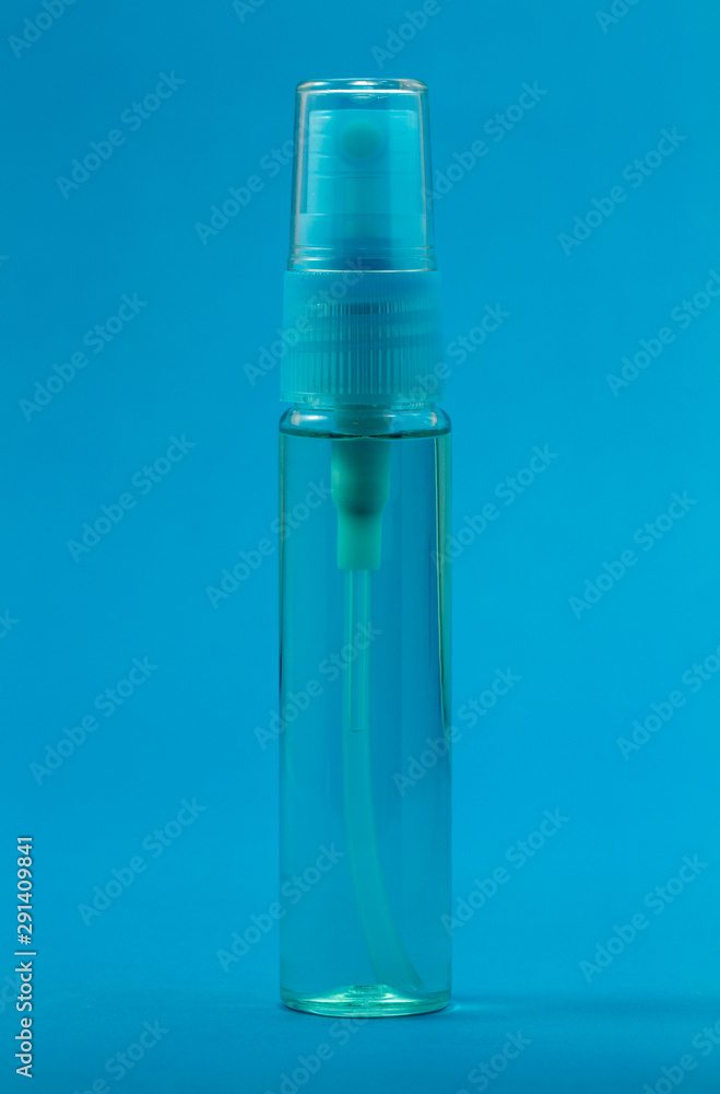 Empty perfume spray bottle isolated on blue Empty perfume spray bottle isolated on blue