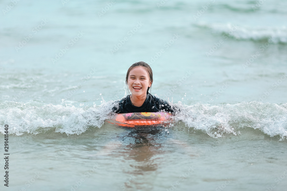 Happy children girl playing in the sea