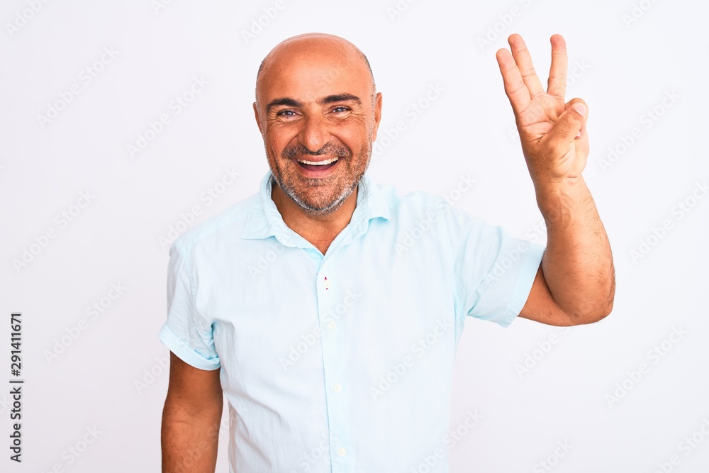 Naklejka premium Middle age handsome man wearing casual shirt standing over isolated white background showing and pointing up with fingers number three while smiling confident and happy.