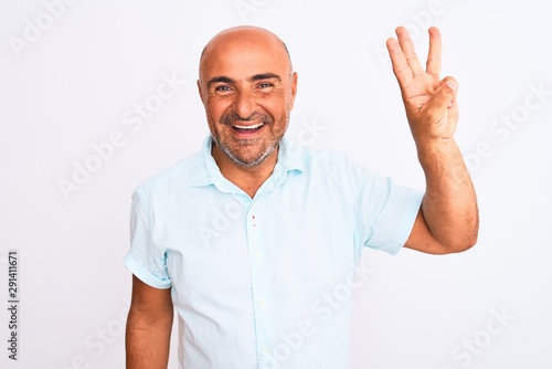 Middle age handsome man wearing casual shirt standing over isolated white background showing and pointing up with fingers number three while smiling confident and happy.