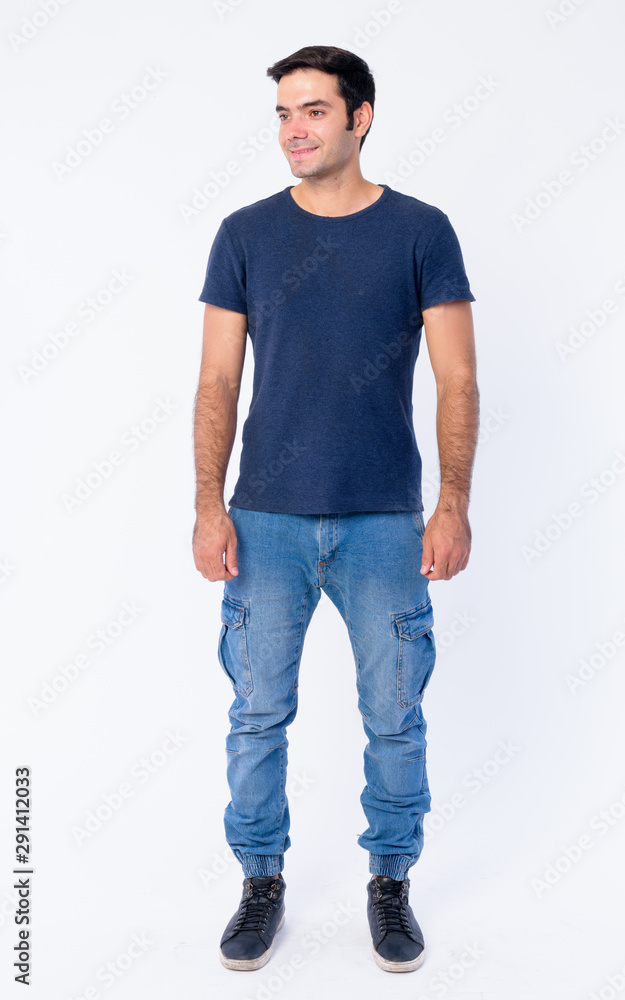 Obraz premium Full body shot of happy young handsome Persian man thinking