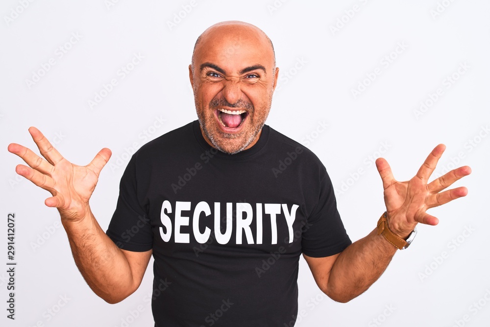 Middle age safeguard man wearing security uniform standing over isolated white background celebrating crazy and amazed for success with arms raised and open eyes screaming excited. Winner concept Middle age safeguard man wearing security uniform standing over isolated white background celebrating crazy and amazed for success with arms raised and open eyes screaming excited. Winner concept