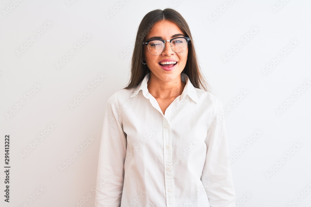 Young beautiful businesswoman wearing glasses standing over isolated white background winking looking at the camera with sexy expression, cheerful and happy face. Young beautiful businesswoman wearing glasses standing over isolated white background winking looking at the camera with sexy expression, cheerful and happy face.