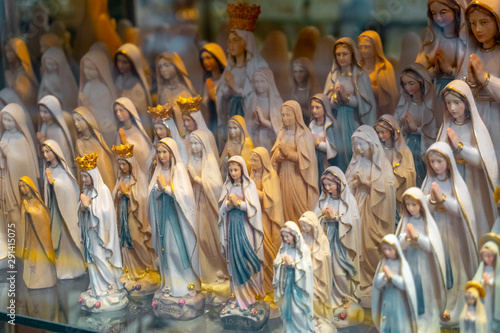 Quadro su tela statues or figurines in a shop, the commercial side of Lourdes.