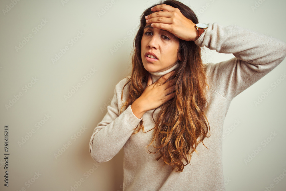 Young beautiful woman wearing winter sweater standing over white isolated background Touching forehead for illness and fever, flu and cold, virus sick Young beautiful woman wearing winter sweater standing over white isolated background Touching forehead for illness and fever, flu and cold, virus sick