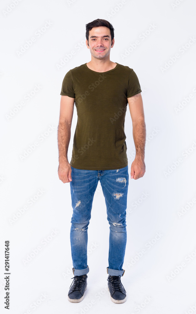 Full body of happy young handsome Persian man smiling Full body of happy young handsome Persian man smiling