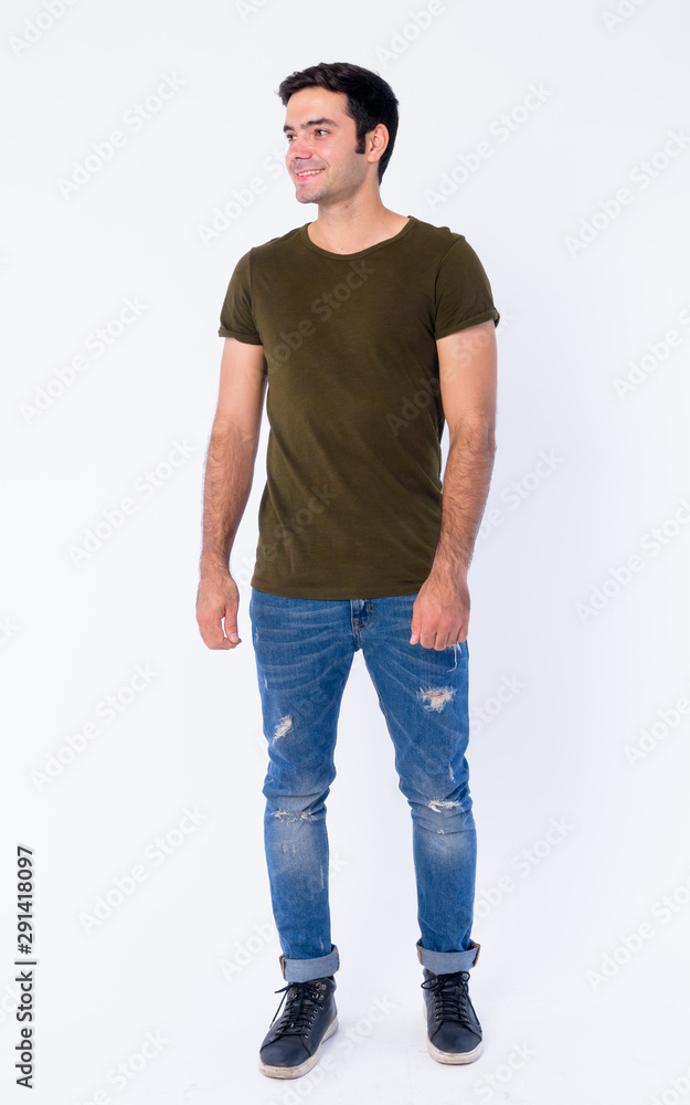 Full body of happy young handsome Persian man thinking Full body of happy young handsome Persian man thinking