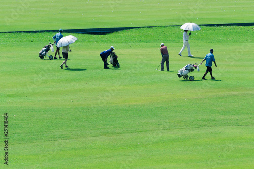 A group of golfers on a golf course.