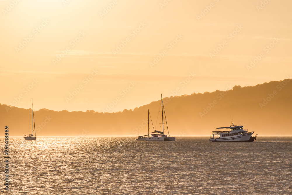 sunset sky over sea and sailboat in the morning sunset sky over sea and sailboat in the morning