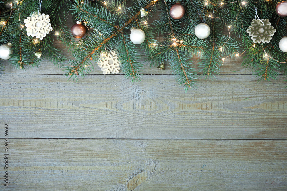Fir tree branches with Christmas decoration on wooden background, flat lay. Space for text - obrazy, fototapety, plakaty 