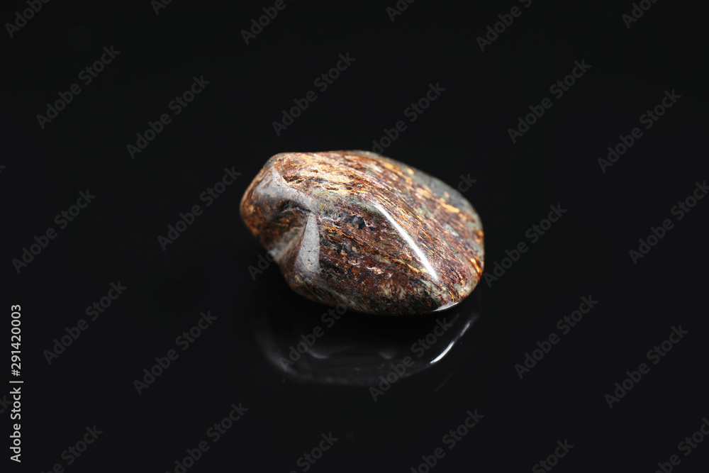 Fototapeta premium Beautiful brown bronzite gemstone on black background