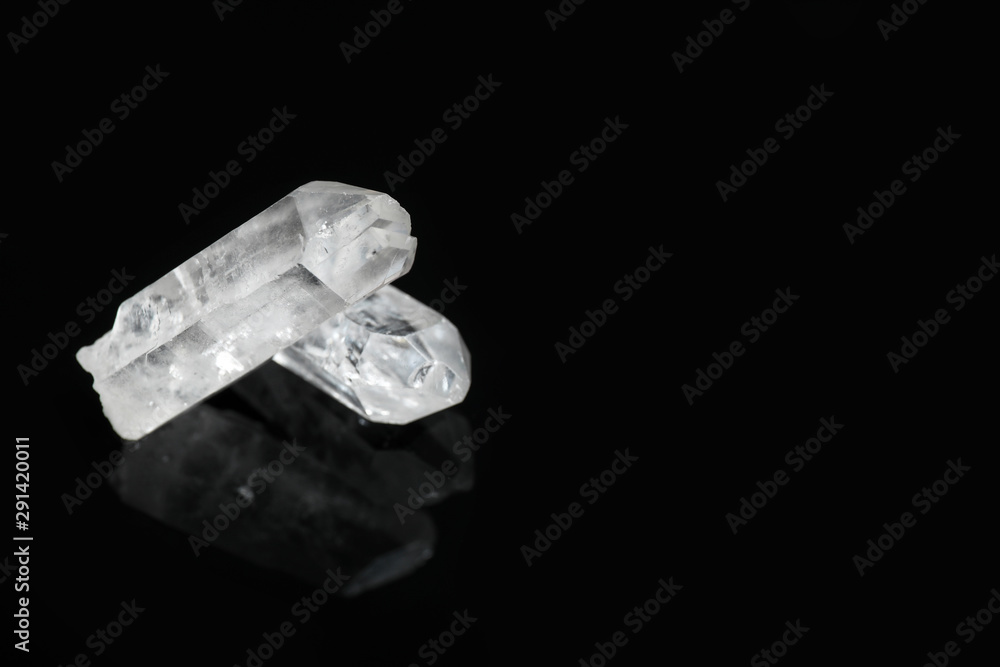 Beautiful rock crystal gemstones on black background. Space for text