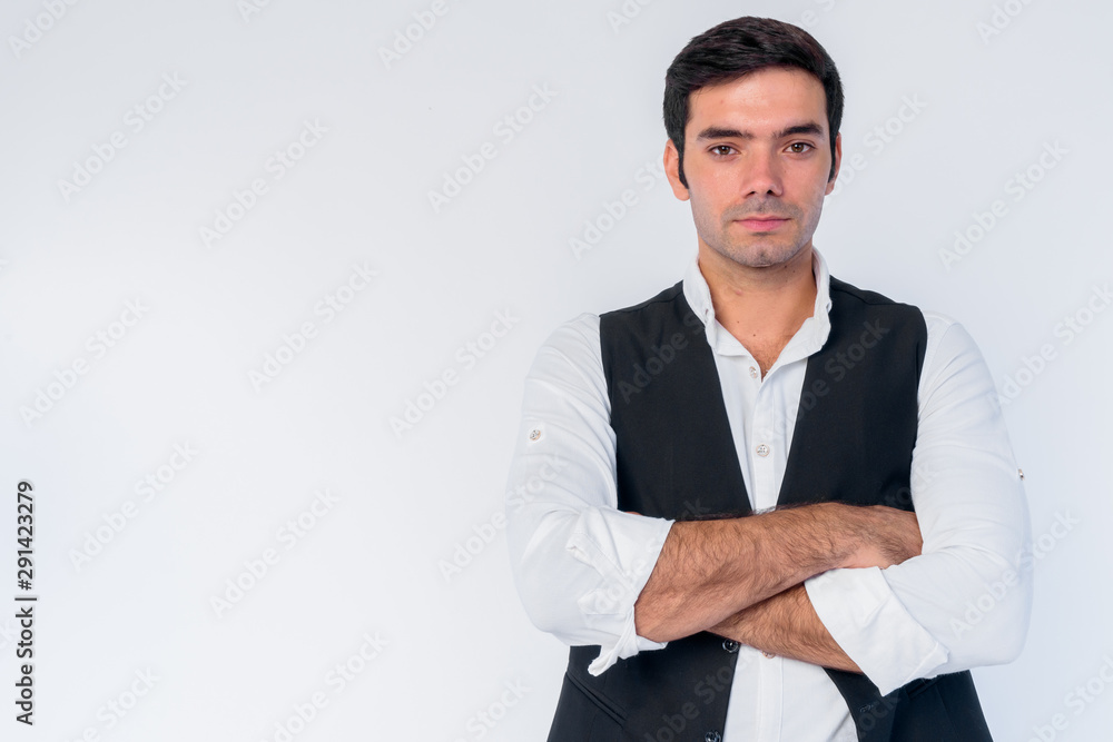 Portrait of young handsome Persian businessman with arms crossed Portrait of young handsome Persian businessman with arms crossed