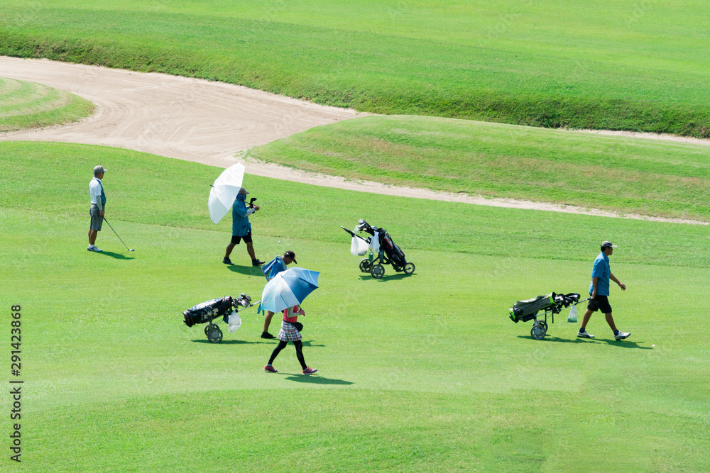 A group of people with golf attributes go to the golf course. A group of people with golf attributes go to the golf course.