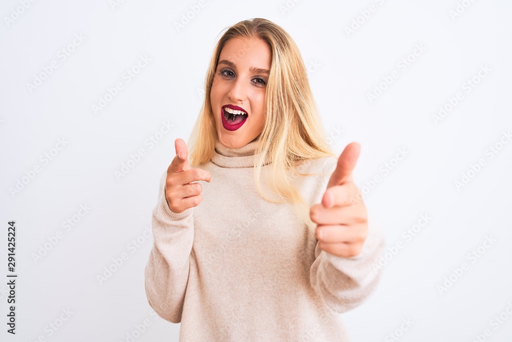 Young beautiful woman wearing turtleneck sweater standing over isolated white background pointing fingers to camera with happy and funny face. Good energy and vibes. Young beautiful woman wearing turtleneck sweater standing over isolated white background pointing fingers to camera with happy and funny face. Good energy and vibes.
