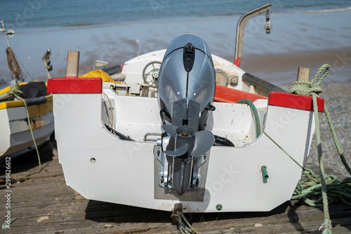 1 Close up of an isolated white fishing boat moored up on the beach