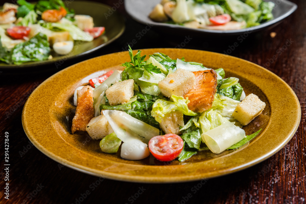 Caesar salad with fresh lettuce, parmesan and fried croutons. Caesar salad with fresh lettuce, parmesan and fried croutons.