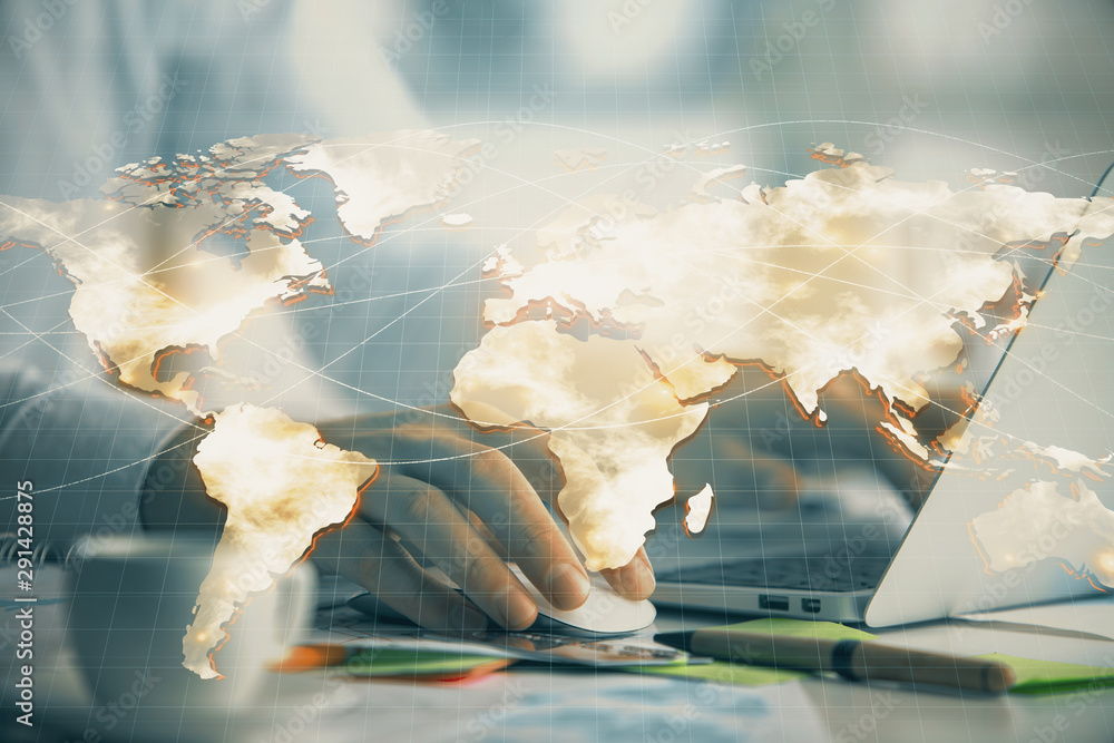 Fototapeta premium Multi exposure of businessman working on laptop on background. International business hologram in front. Concept of success.