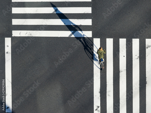 Aerial view of people passing crosswalk in the downtown street.