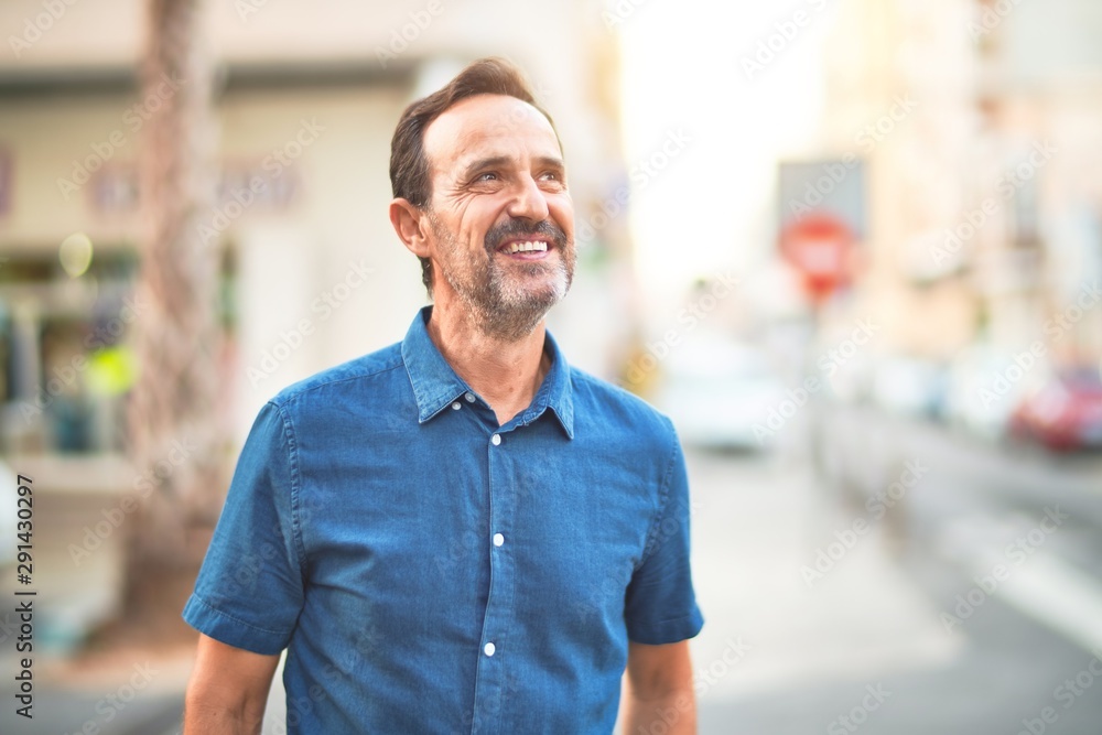 Middle age handsome man standing on the street smiling Middle age handsome man standing on the street smiling