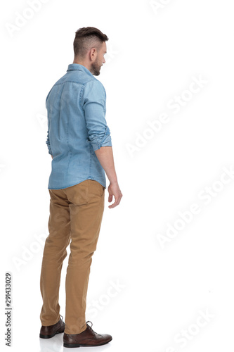 casual man standing and looking away pensive