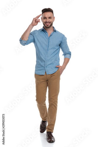 casual man walking with hand in pocket and saluting