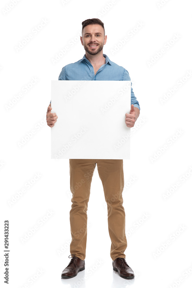 casual man standing with billboard on hands happy casual man standing with billboard on hands happy