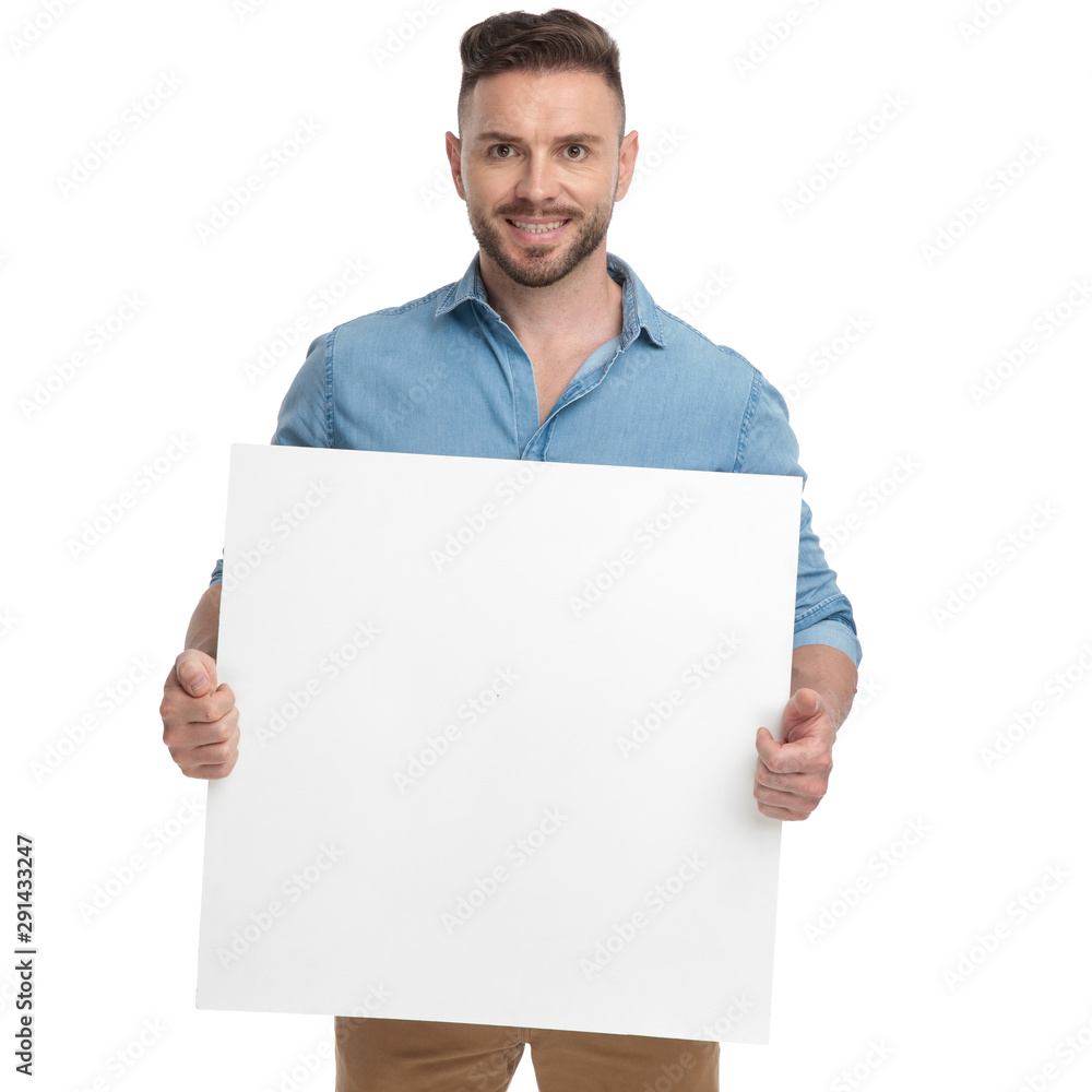 casual man standing with billboard on hands happy casual man standing with billboard on hands happy