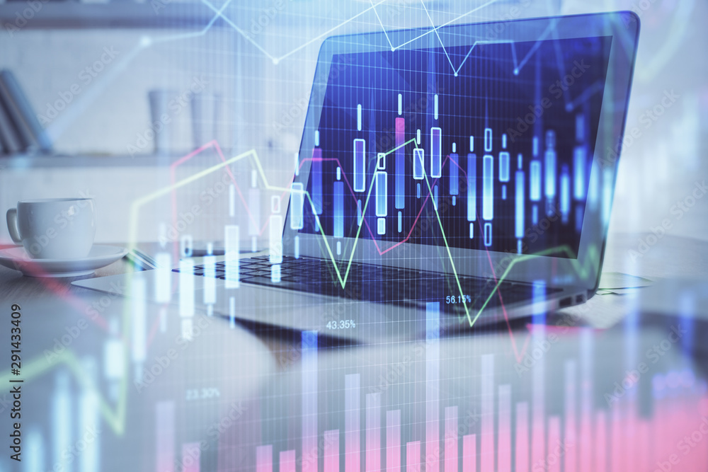 Forex Chart hologram on table with computer background. Double exposure. Concept of financial markets. Forex Chart hologram on table with computer background. Double exposure. Concept of financial markets.