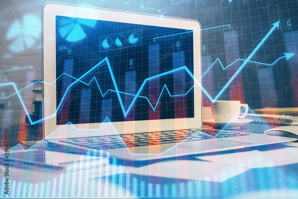 Financial chart drawing and table with computer on background. Double exposure. Concept of international markets. Financial chart drawing and table with computer on background. Double exposure. Concept of international markets.
