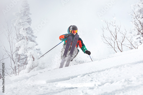 Professional skier freerides in forest