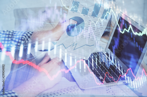 Double exposure hands with stock market chart. Concept of research and analysis.