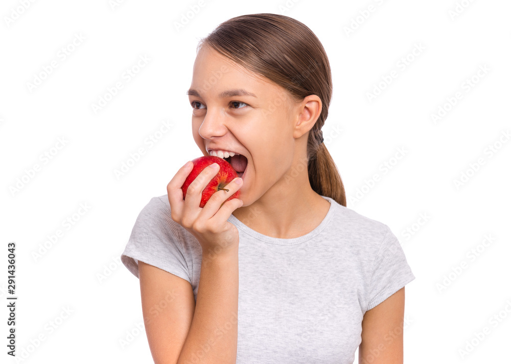 Portrait of beautiful young teen girl holding fresh red apple, isolated on white background. Portrait of cute happy child bites apple. Delicious vegetables, organic natural healthy food produce. Portrait of beautiful young teen girl holding fresh red apple, isolated on white background. Portrait of cute happy child bites apple. Delicious vegetables, organic natural healthy food produce.
