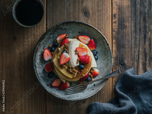 pancakes topped with banana and berry