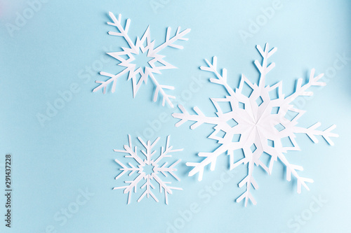 blue background with paper snowflake, top view
