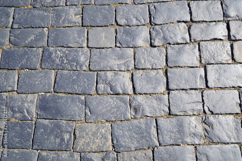 Square granite stones. Stone pavement texture