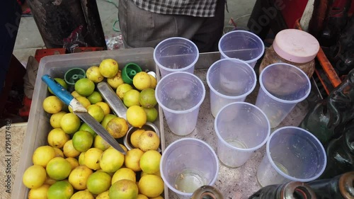 Street vendor in Delhi preparing a glass of Lemon or Nimbu Soda or Banta, a drink which helps acidity to cool down and give your fried food a chill. Popular in north Indian summer. 4k 60fps gimbal  photo