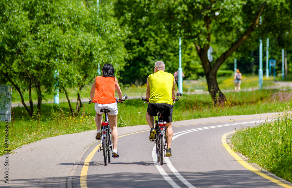 Cyclists ride on the bike path in the city Park 