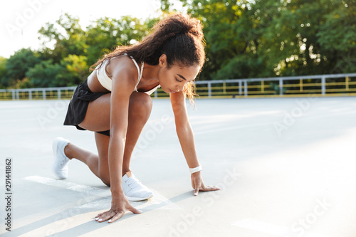 Photo of african american brunette woman doing exercise