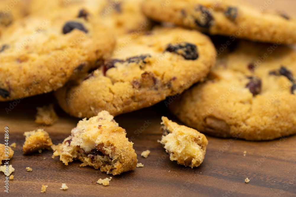 Pile of delicious tasty recipe apple cookies homemade with crack small pieces isolated on wooden table Pile of delicious tasty recipe apple cookies homemade with crack small pieces isolated on wooden table