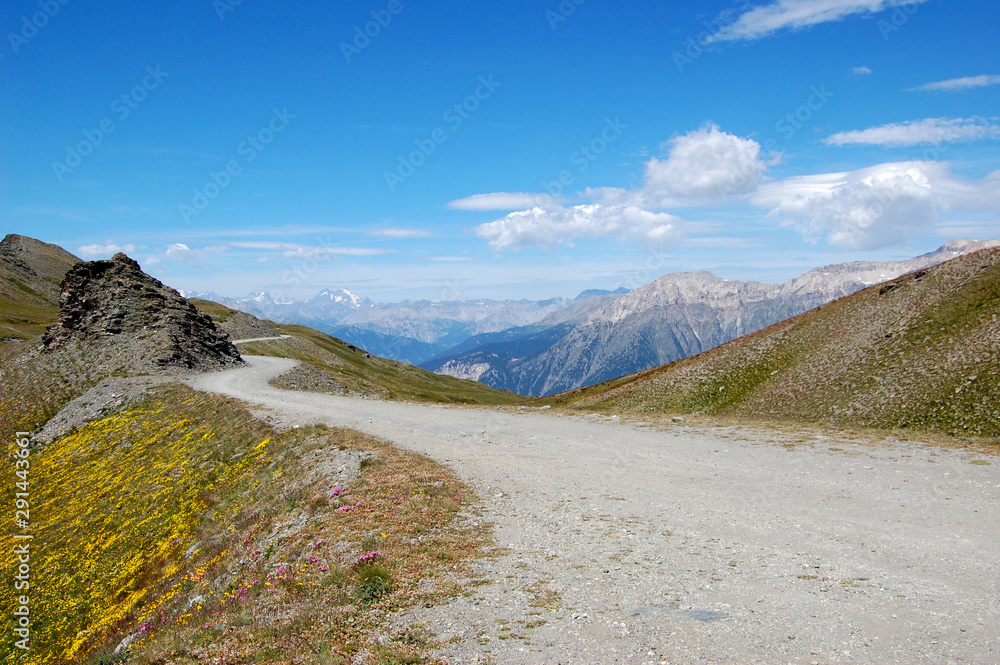 Landscape of dirt road in mountain high altitude in Piedmont italy mountain and blue sky Landscape of dirt road in mountain high altitude in Piedmont italy mountain and blue sky