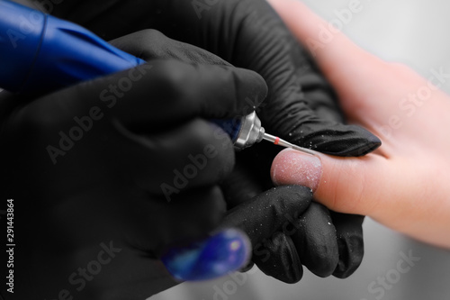 Manicure  cleaning of nails by a milling cutter.