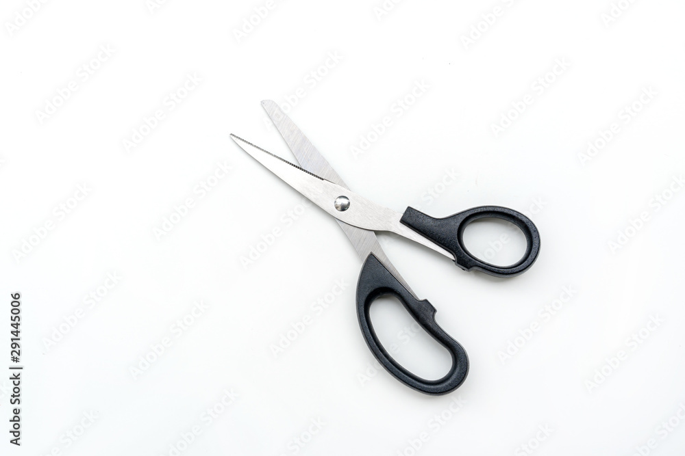 Open pair of scissors with black handle isolated on white background, top view Open pair of scissors with black handle isolated on white background, top view